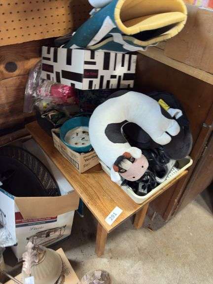 Small table, neck pillows, cordless phones, misc image