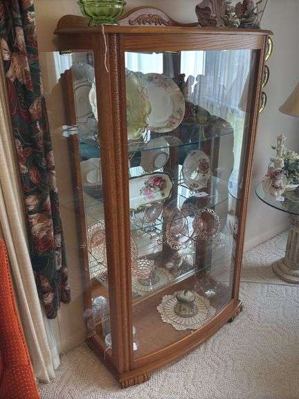 Oak lighted display case with curved glass front, mirrored back, glass shelves 33" x 59" x 15"