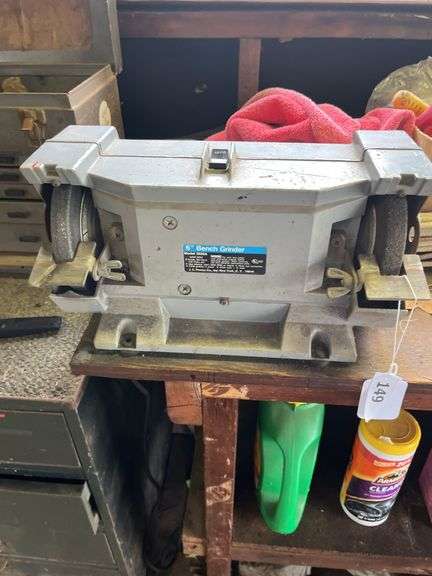 Wood bench w/ double end grinder, yard chemicals, rope, plastic owl & misc