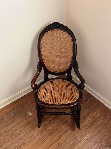 Antique carved back rocker w/ cane seat & back