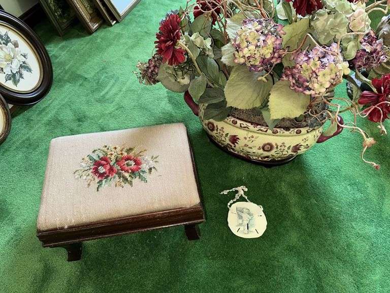 Needlepoint step stool, large floral arrangement in ceramic planter, sand dollar ornament