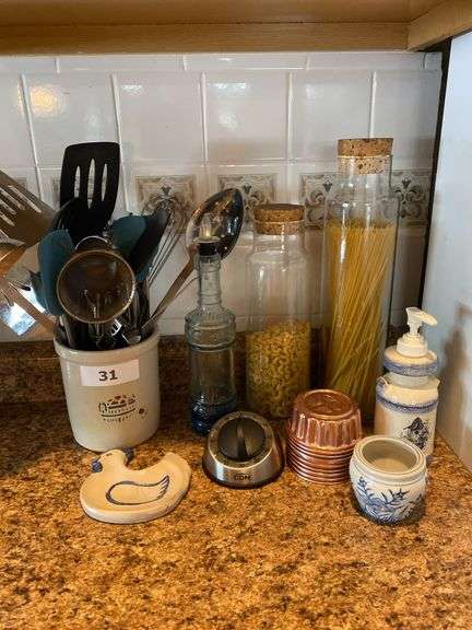 Kitchen utensils in crock, pasta jars, oil decanter, miscellaneous