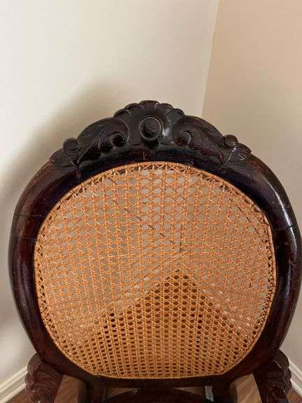 Antique carved back rocker w/ cane seat & back