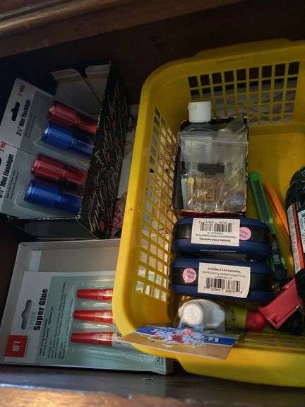 Bottom drawer of dresser, lights, glue, scissors, wire strippers, miscellaneous image