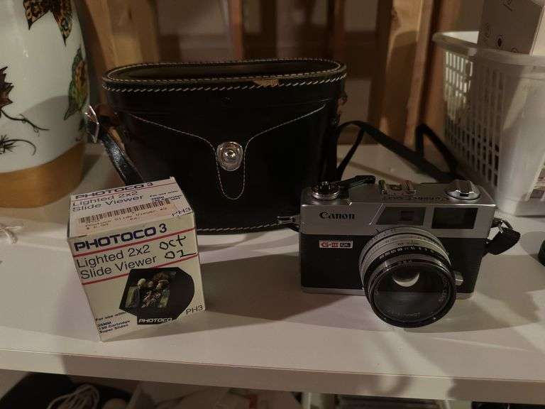 Binolux binoculars, Sitacon camera, Fuji camera, Cannon Canonet QL17 camera, lighted slide viewer image
