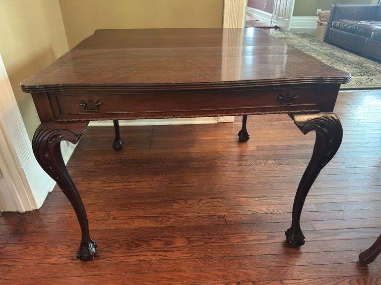Antique table with built in drop leaf and claw feet and drop down legs
