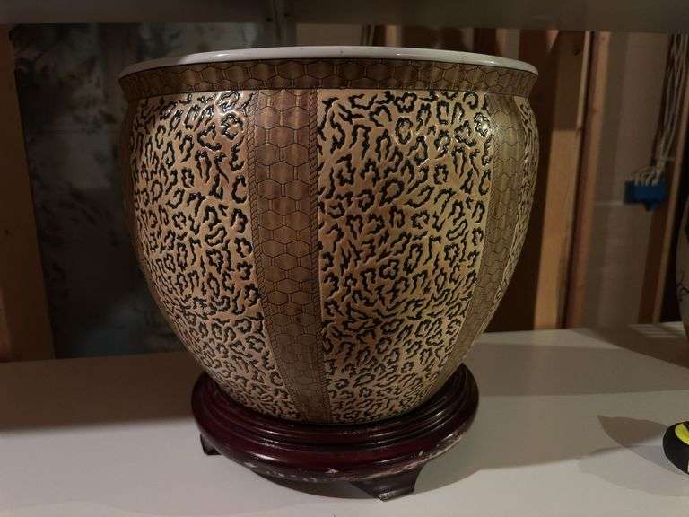 Large ceramic pot on wooden base image