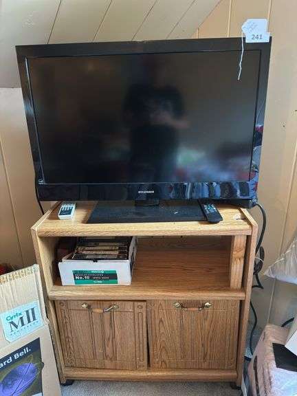 36” Sylvania tv with remote with tv cart and accessories  28” t X 28” w X 16” d. 2 door ( some damage on top) image