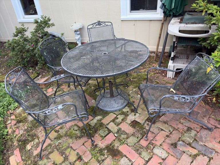 Wrought iron patio table w/ 4 chairs (1 bent), 3 umbrellas image