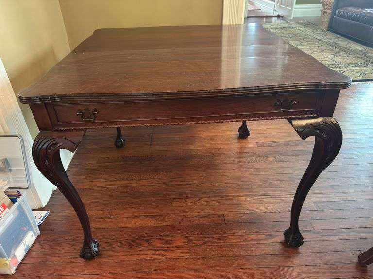 Antique table with built in drop leaf and claw feet and drop down legs