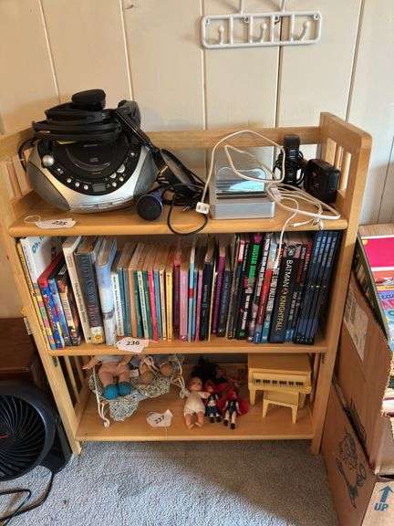 2 bookcases. 1 wood 33” h X 27” w X 11” d. No contents. White plastic bookcase is  29” h X 30” w X 10” d. No contents image