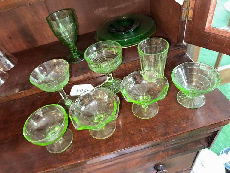 Uranium glass sherbets, stemmed glasses, cup, green depression glass plates, glass image