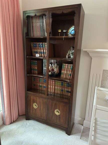 Vintage wooden bookshelf with cabinet doors on bottom