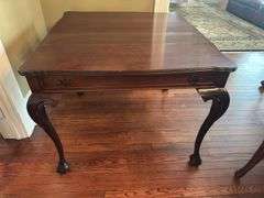Antique table with built in drop leaf and claw feet and drop down legs