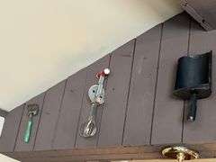Antique kitchen utensils on wall