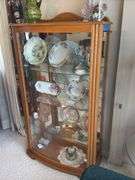 Oak lighted display case with curved glass front, mirrored back, glass shelves 33" x 59" x 15"