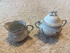 Antique double handle jar with lid, doily, china creamer & sugar
