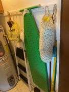 Contents of kitchen closet, step stool, ironing board, brooms, extension cords (excludes items on shelf)