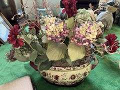 Needlepoint step stool, large floral arrangement in ceramic planter, sand dollar ornament