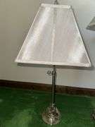 Table lamp with glass cylinder base and silver decorative accents and checked shade 36” tall, metal base lamp with triangle shade 26” tall