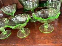 Uranium glass sherbets, stemmed glasses, cup, green depression glass plates, glass