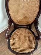 Antique carved back rocker w/ cane seat & back