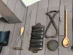 Antique kitchen utensils on wall