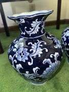 Pair of blue and white decorative vases with scalloped tops