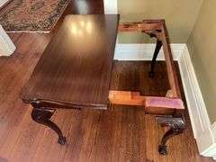 Antique table with built in drop leaf and claw feet and drop down legs