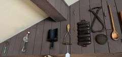 Antique kitchen utensils on wall