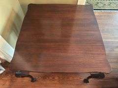 Antique table with built in drop leaf and claw feet and drop down legs