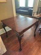 Antique table with built in drop leaf and claw feet and drop down legs