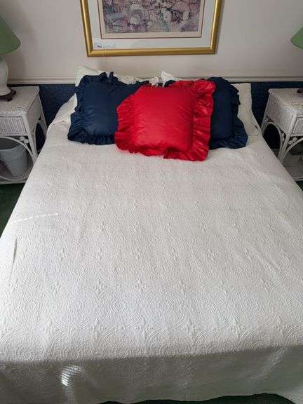 Queen size bed with bedding and pillows, foam wedge image