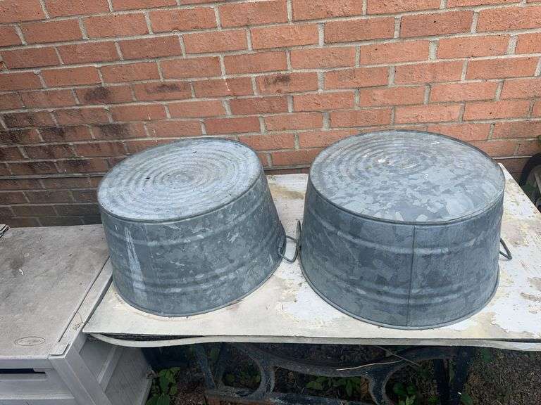 2 galvanized tubs, hose reel box, plastic wheel barrow (damaged), flower pots, trash cans image