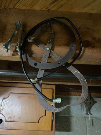 Items hanging from rafter, vintage ice tongs, hand corn busker, gaskets, miscellaneous image