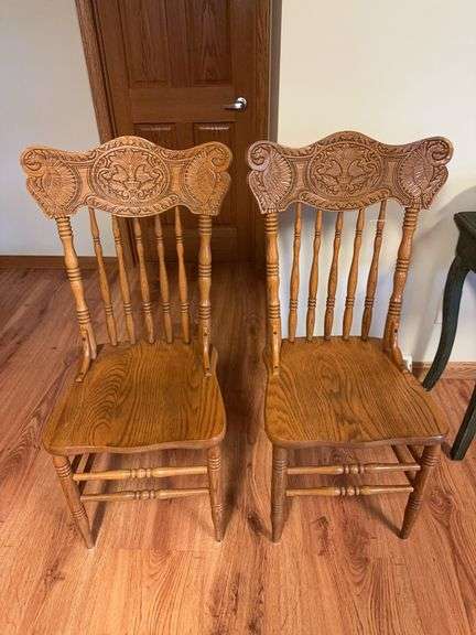 Pair of oak kitchen chairs with carved backs image