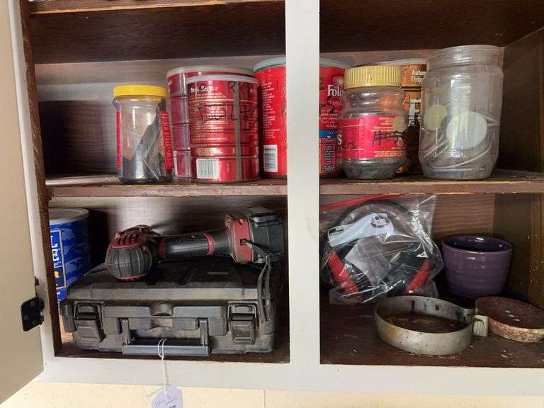 Bottom 2 shelves of upper cabinet - misc hardware, drill, casters, faucet image