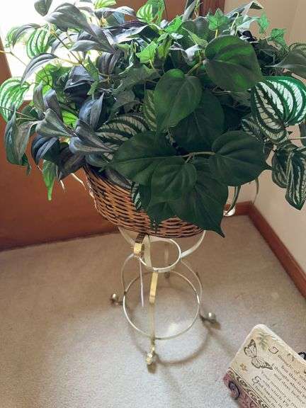Gold metal plant stand with wicker basket and plant image