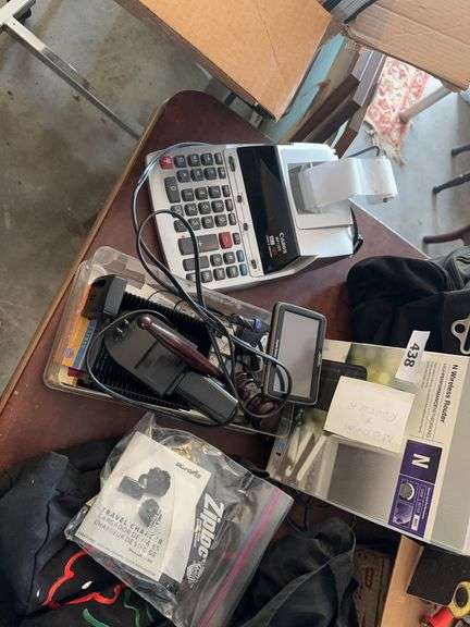 Wireless router, calculator, cables, travel chargers, image