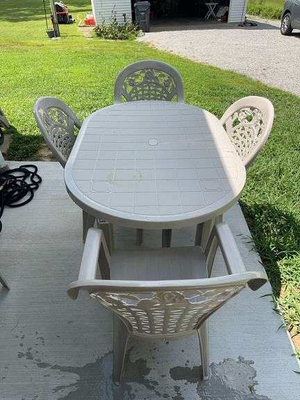 Plastic patio table with 5 chairs image