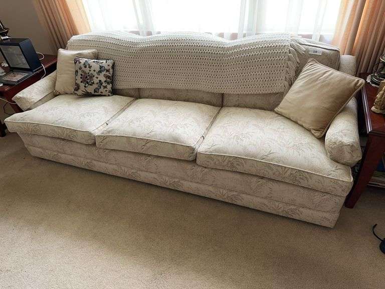 3 cushion white sofa with pillows and afghan image