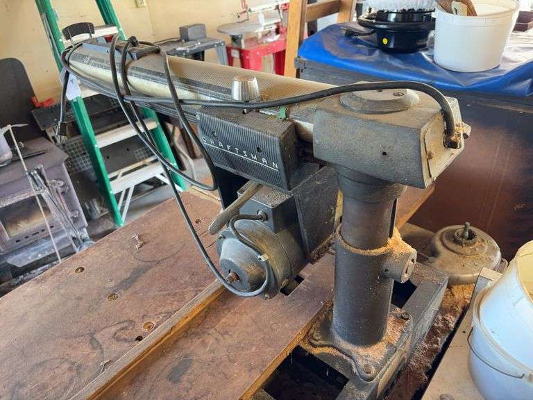 Craftsman radial arm saw on wood cabinet image