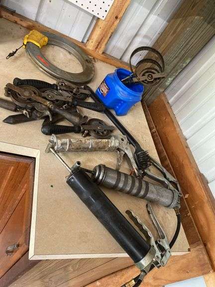 Grease guns, grill scraper, fish tape winder, oil gauging tapes image