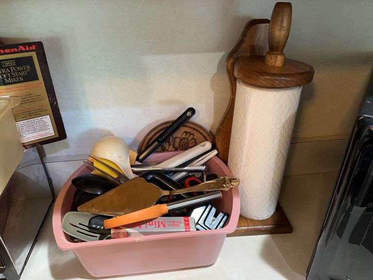 Lot of kitchen utensils, wooden paper towel holder, trivet image