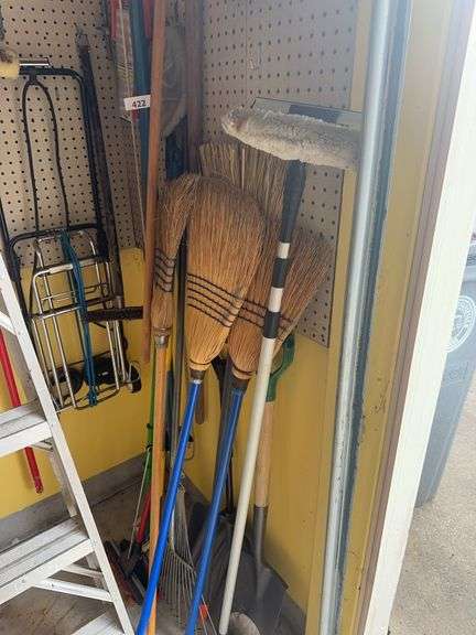 Tree trimmer, brooms, rake, dust pans, wheeled carrier. push broom, shovels image
