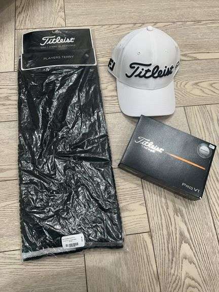 Titleist hat, box of Titleist ProV1 golf balls, Titleist players terry towel image