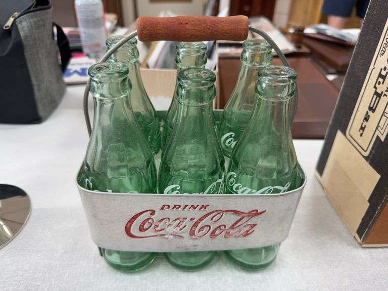 Vintage Coca-Cola bottles in metal caddy image
