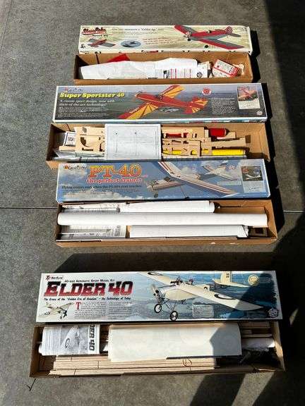 4 airplane kits: opened, one appears to be complete image