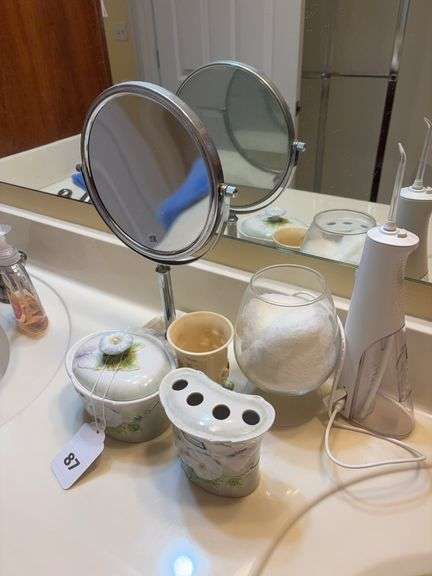Make up mirror, tooth brush holder, water pic, misc image