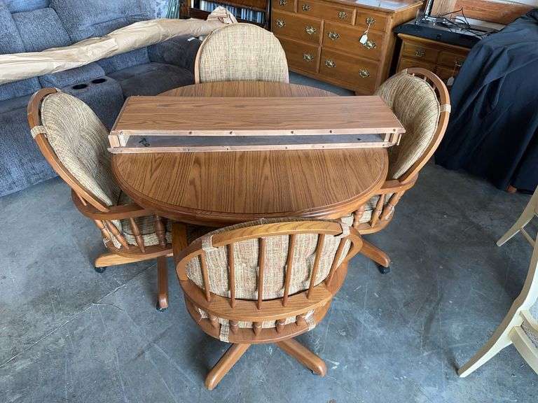 46" Oak Pedestal Table with 4 rolling chairs and two 12" leaves image